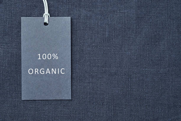 Label on linen fabric background. 100% organic materal