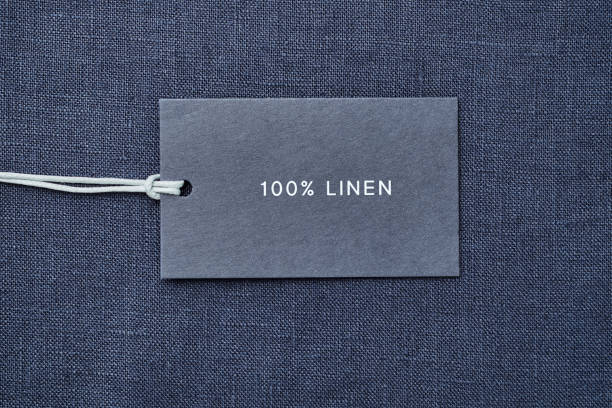 istock Label with composition of fabric on cloth background. 100% linen 1163375000