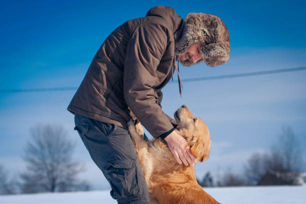 istock Man hiker and his dog on a mountain top 1163375938