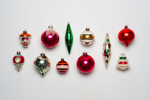 Assortment of Christmas ornaments from the 1930’s on a white background.