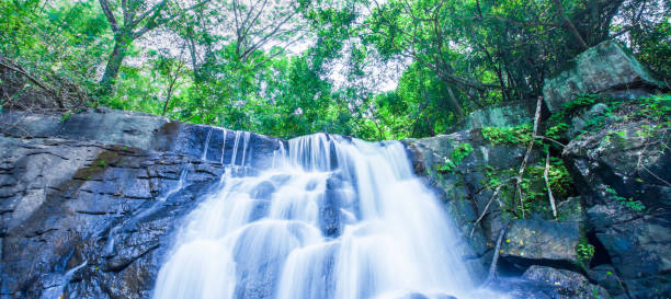 istock Ancient tropical waterfall falling on layers of the steeply. 1163376512