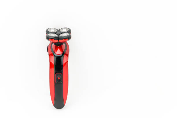 Electric hand-held red and black shaver for hair salon or barber shop on the white mat background