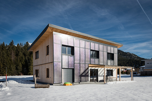 self-sustaining sun solar house with panels at front in winter