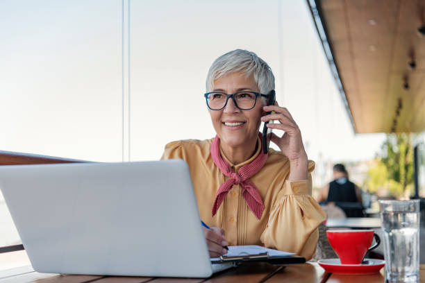 istock Mature business woman at cafe using laptop 1163380892
