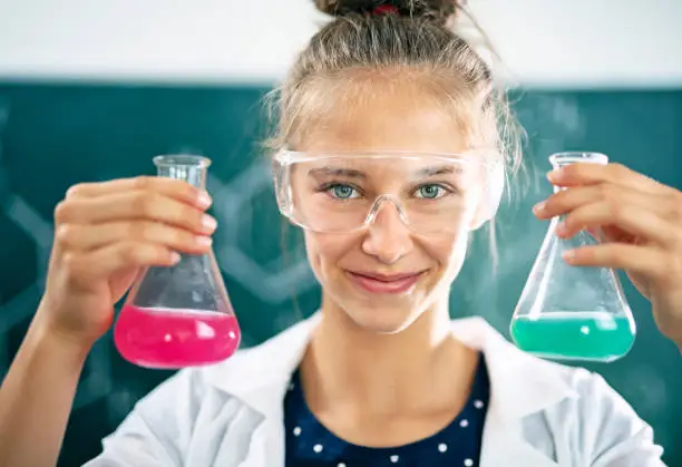 Photo of Teenage girl enjoying chemistry lesson