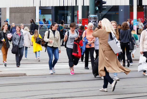 People at a crosswalk Oslo, Norway, June 20, 2019. People crossing the street at a crosswalk near the Central station. busy oslo street norway stock pictures, royalty-free photos & images