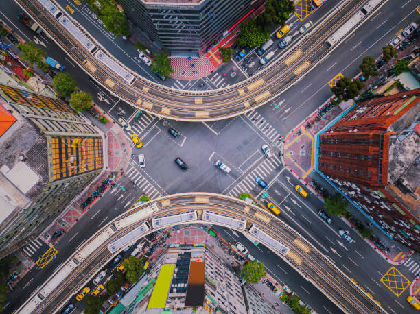 aerial view of cars and trains with intersection or junction with traffic, taipei downtown, taiwan. financial district and business area. smart urban city technology. - road top view imagens e fotografias de stock