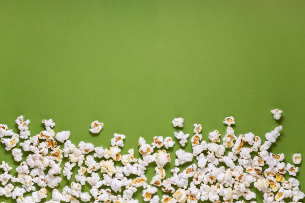 istock White tasty popcorn on a green background. Popcorn pattern on green background. Top view. Copyspace for your text. 1163388742