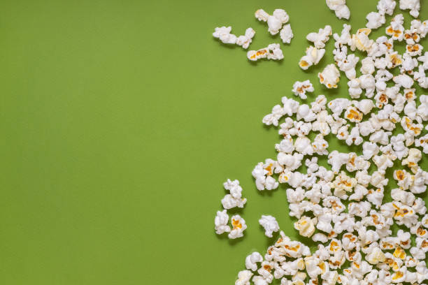 istock White tasty popcorn on a green background. Popcorn pattern on green background. Top view. Copyspace for your text. 1163388753
