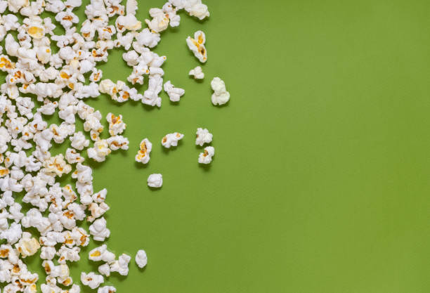 istock White tasty popcorn on a green background. Popcorn pattern on green background. Top view. Copyspace for your text. 1163388756