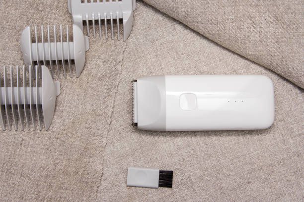 istock Mobile hair clipper on fabric background. 1163391693