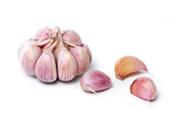 istock Garlic bulb and garlic cloves isolated on white background. 1163391722