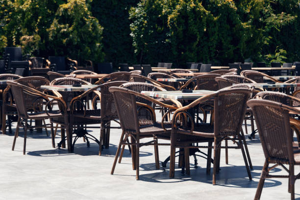 istock Empty tables in an open-air cafe at noon. Hot summer day 1163392999