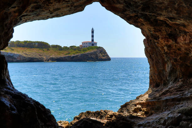 istock rock window with lighthouse - Porto Colom Mallorca Balearic Islands Spain 1163397756