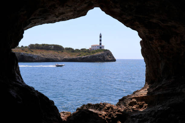 istock rock window with lighthouse - Porto Colom Mallorca Balearic Islands Spain 1163397759