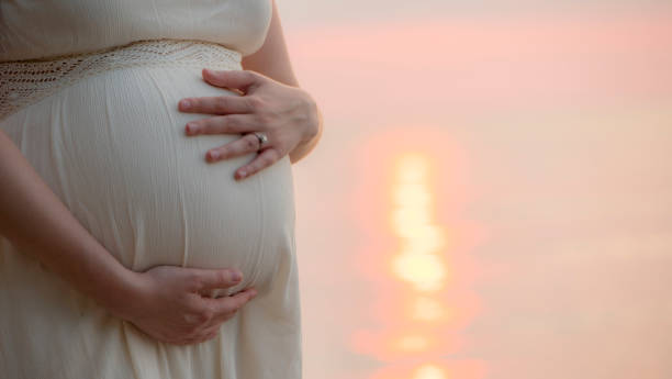 istock Pregnant woman stroking her belly 1163397980