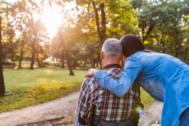 istock Disabled Man on Wheelchair with Girlfriend in Park 1163398026