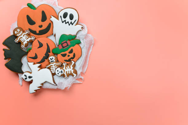 istock The hand-made eatable gingerbread Halloween pumpkin, ghosts, bat and sceletons on pink background 1163402646
