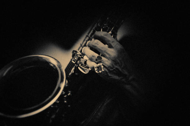 The saxophone player at the jazzclub Saxophone, Player, vintage, dark, art, jazz, performance group photos stock pictures, royalty-free photos & images