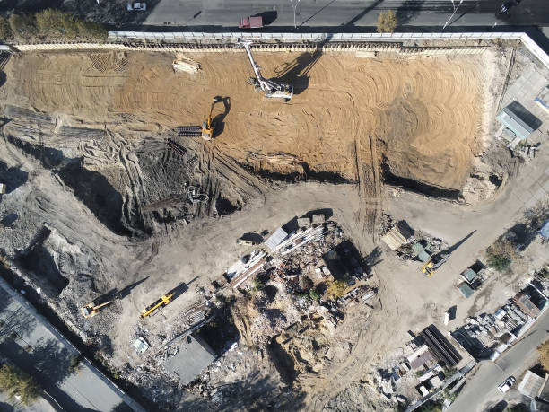 istock Construction site aerial view. Mall building base with solid concrete pillars. Heavy machinery piling and high tower crane working. Industrial aerial background 1163408253
