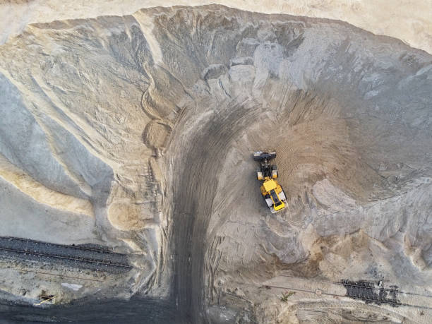 istock Big heavy wheel loader loading sand into dump truck in sand pit. Heavy industrial machinery concept 1163409540