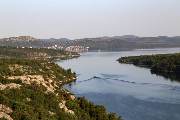 Krka river estuary from the Skradin - Krka bridge.Krka river estuary from the Skradin - Krka bridge and a statue of Mary, Mother of God