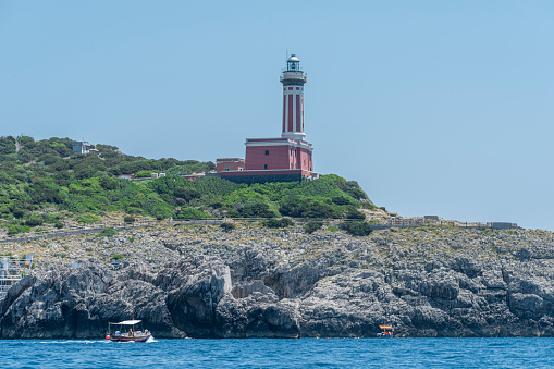 View of Punta Carena Lighthouse (Faro di Punta Carena) in the south west coastline in the Island of Capri in the Tyrrhenian Sea in Italy. It was built in 1862.