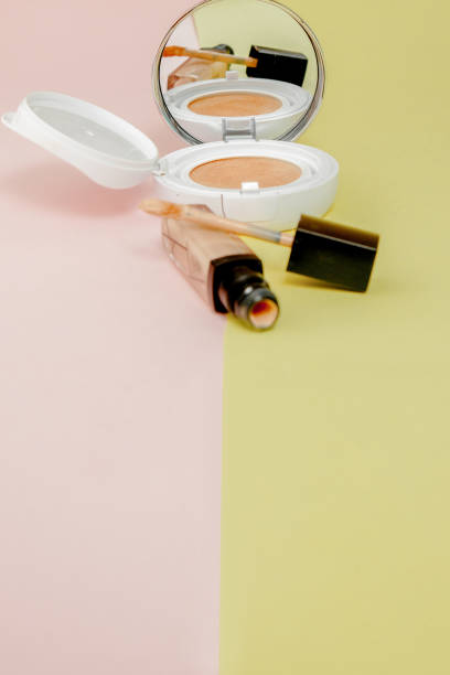 istock Make up products spilling on to a bright yellow and pink background with copy space 1163413997