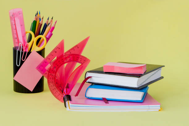 istock Back to school concept with space for text. Copy space. School office supplies.Creative desk with colourful stationery. Colored paper clip.School supplies on yellow background.Office desk 1163414076
