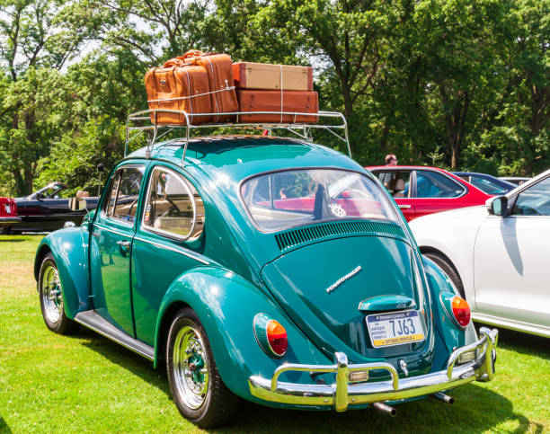 1967 vw beetle with a filled luggage rack - beetle imagens e fotografias de stock