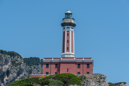 View of Punta Carena Lighthouse (Faro di Punta Carena) in the south west coastline in the Island of Capri in the Tyrrhenian Sea in Italy. It was built in 1862.