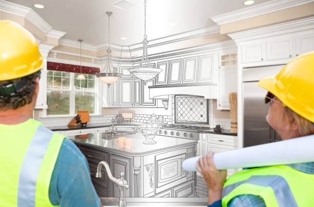 istock Male and Female Contractors Overlooking Kitchen Drawing Transition to Completed Project 1163418258