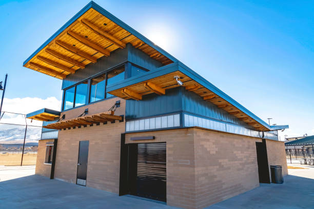 istock Park building with flat roof and brick wall under blue sky and bright sun 1163419689