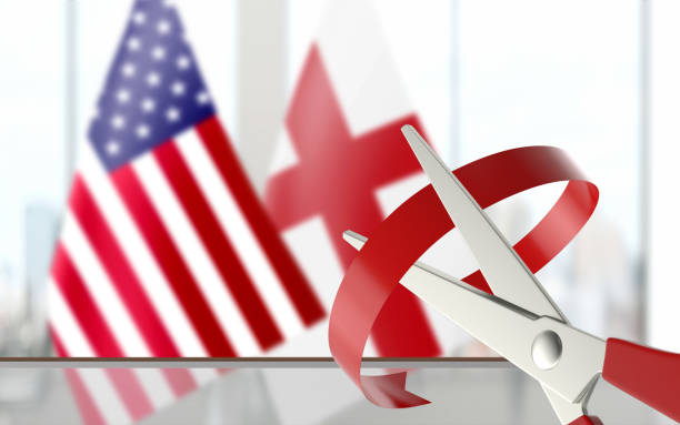 istock Flags are Paired at Background While Scissors is Cutting Ribbon 1163422495