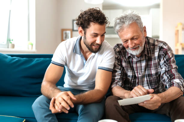 istock Son With His Senior Father at Home Spending Time Together 1163422735