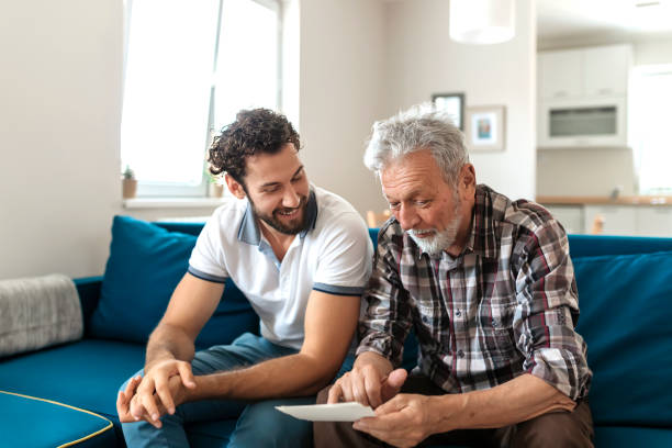 istock Son With His Senior Father at Home Spending Time Together 1163422757