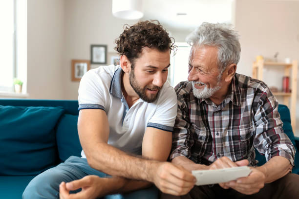 istock Son With His Senior Father at Home Spending Time Together 1163422758