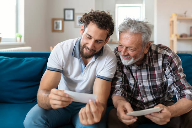 istock Son With His Senior Father at Home Spending Time Together 1163422770
