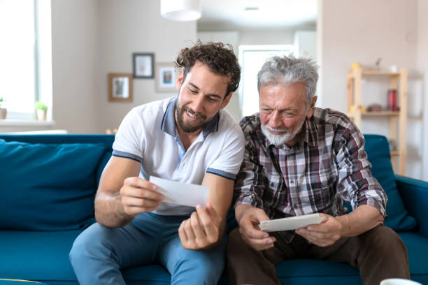 istock Son With His Senior Father at Home Spending Time Together 1163423444