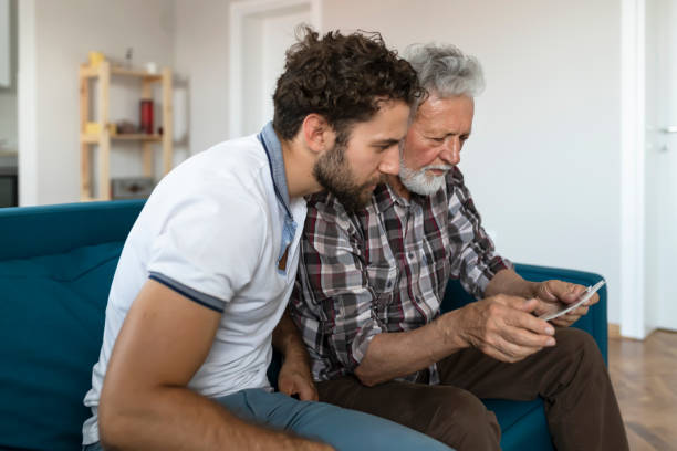 istock Son With His Senior Father at Home Spending Time Together 1163423582