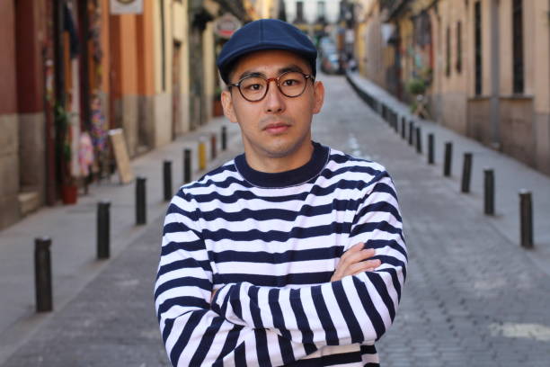 istock Trendy Asian man with arms crossed 1163424245