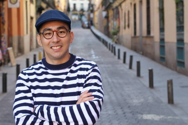 istock Cute Asian man smiling outdoors 1163424255