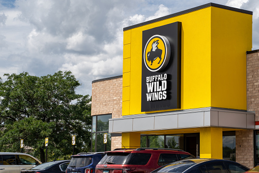Crystal, Minnesota - July 21, 2019: Exterior of a Buffalo Wild Wings chain restaurant. Also known as B-Dubs, this dine-in establishment sells chicken wings and pub food