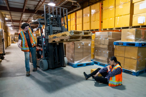 istock An industrial warehouse workplace safety topic. A forklift driver hits a worker. 1163426909