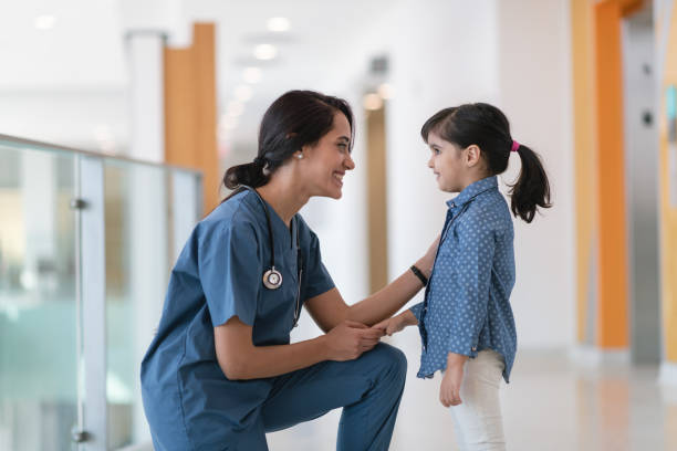 istock Kind medical professional meets with child patient 1163427859