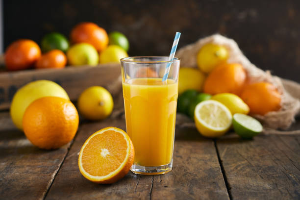 istock Orange juice in a glass with paper straw 1163427892