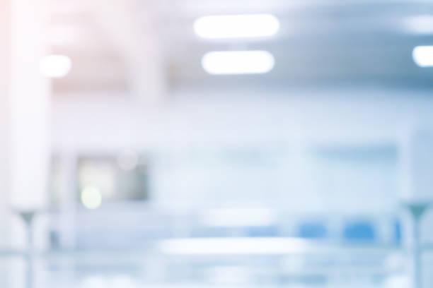 istock abstract blur soft focus blue color interior of modern cleaning workplace background with orange shine light for design concept 1163429077