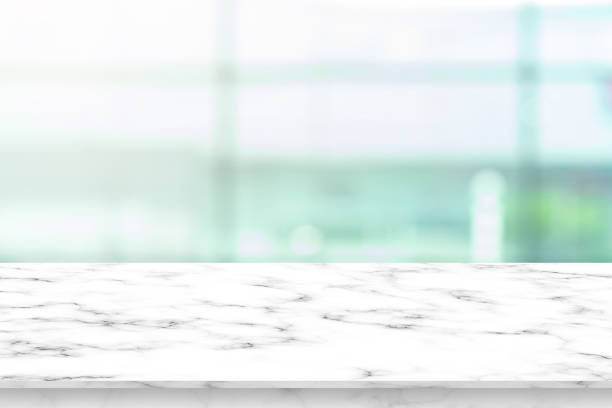istock blurred morning light of inside interior luxury modern bathroom background with white marble pattern tabletop for show,ads,design product on display concept 1163429370