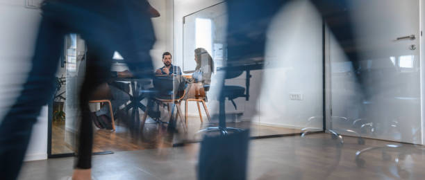 Business Colleagues in Motion Past Office Conference Room