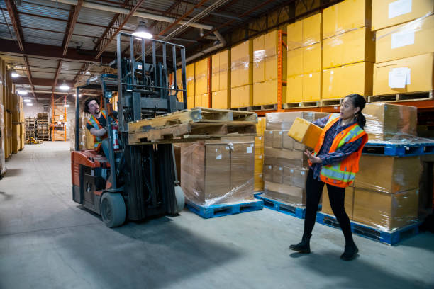 istock An industrial warehouse workplace safety topic. A forklift driver almost runs over a worker. 1163431709